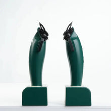 Two green mechanical devices on a white background