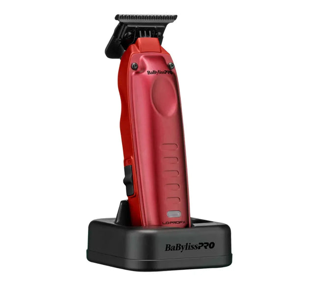 A red BabylissPRO Lowlift pet clipper standing upright on a black charging dock against a solid white background.