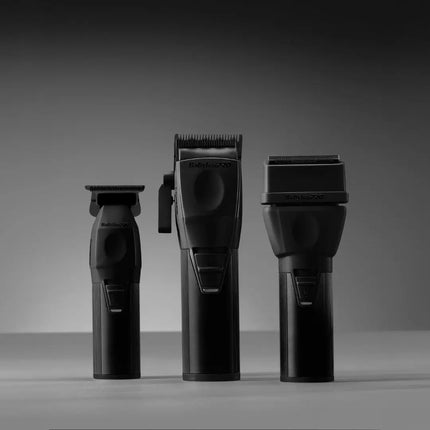 Three black Braun Series 3 grooming devices, including a trimmer, a clipper, and a shaver head, displayed side-by-side on a neutral gray studio background.