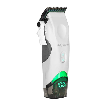 A white and grayBaBylissPRO Tomb45 White Wireless cordless hair clipper with a green illuminated trim line and a transparent collection container at the base, shown on a solid white background.