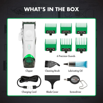 Box contents layout for a BaBylissPRO Tomb45 White Wireless set on a dark background with a white bordered panel. The set includes a white and green clipper, six green guide combs, a cleaning brush, a tube of lubricating oil, a charging cord, a blade cover, and a screwdriver.