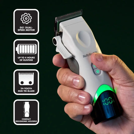 A hand holding a white and gray BBaBylissPRO Tomb45 White Wireless with a green illuminated display, shown against a dark green background with four feature callout icons on the left.