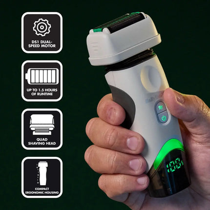 A babyliss electric shaver with a white and dark gray body, green accents, and a small digital display, shown being held in a hand against a dark background. Four black feature icons on the left highlight a dual-speed motor, up to 1.