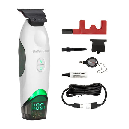BaBylissPRO Tomb45 electric hair trimmer shown with multiple included accessories on a plain white background, including a red stand, black attachment pieces, a charging cable, a small bottle, and a retractable reel.