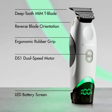 A white and black Babyliss Pro Tomb45 electric hair clipper with green LED battery display, shown with text callouts highlighting features like Deep-Tooth MIM T-Blade, Reverse Blade Orientation, Ergonomic Rubber Grip, DS1 Dual-Speed Motor, and LED Battery Screen.