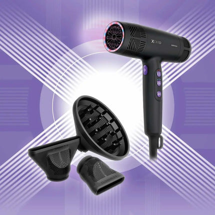 Black X-Fold hair dryer with purple buttons, shown with three black styling attachments against a purple and white graphic background.