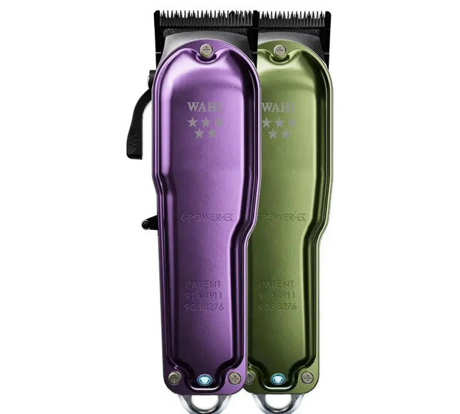 Purple and green Wahl hair clippers on a white background