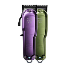 Purple and green Wahl hair clippers on a white background