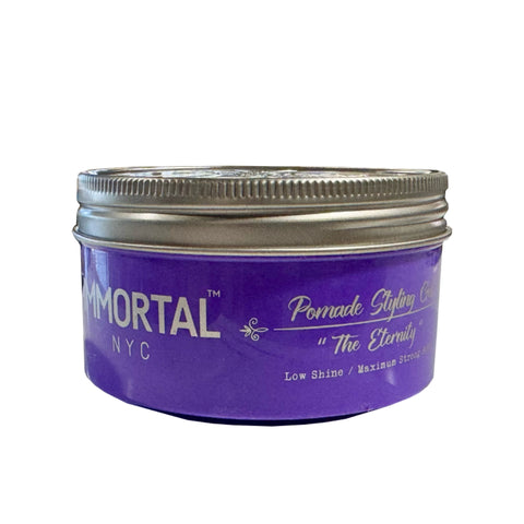 “Model shaping a textured pompadour with The Eternity Pomade Gel, achieving matte definition.”

