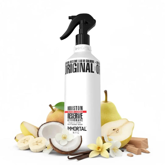 A bottle of Houston Reserve aftershave with fruit and vanilla elements on a white background