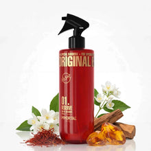 Reserve 01 Gold Edition After Shave Cologne Red bottle with black pump labeled 'Original' surrounded by flowers and amber on a white background