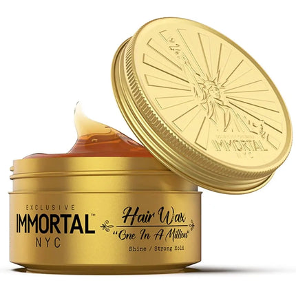 Gold container of Immortal NYC hair wax with open lid on a white background