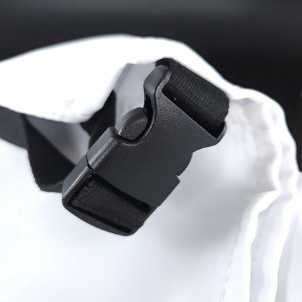 StyleCraft Pro Apron Close-up of a black buckle on a white bag with a blurred background