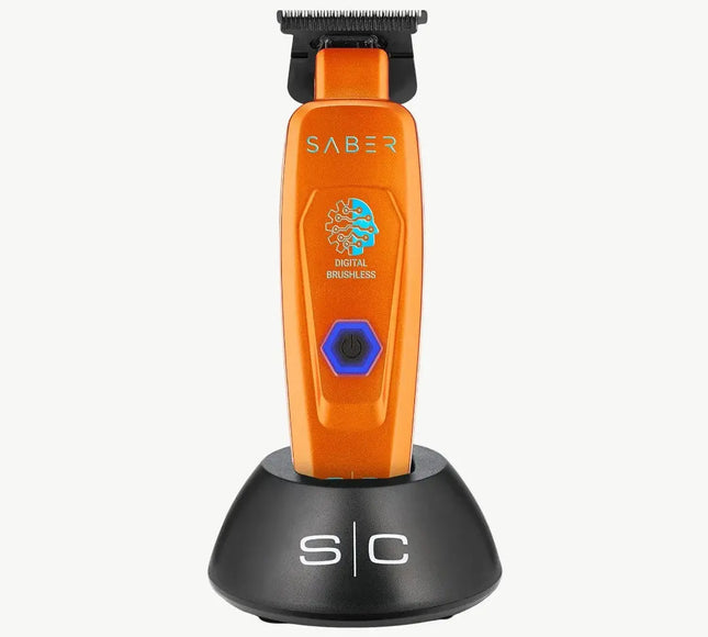 An orange SABER digital brushless electric trimmer standing upright on a black charging dock against a light gray background.