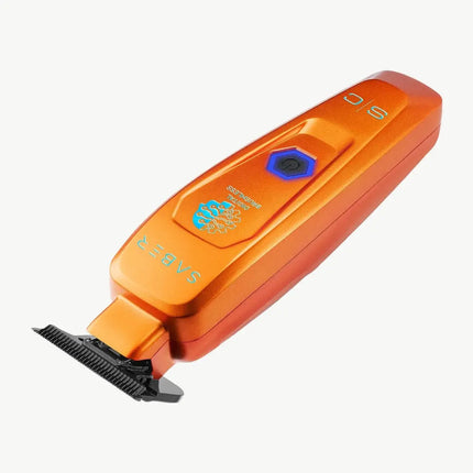An StyleCraft Saber Professional Hair Trimmer – Limited Edition Orange with a black blade attachment, featuring a blue power button and light blue branding text on a clean white background.