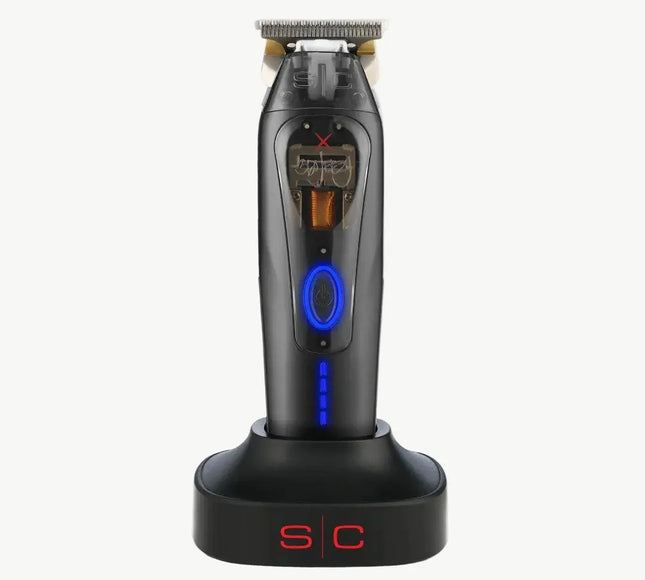 A black cordless electric shaver with blue LED accents, standing upright on a matching black charging dock with red 'S/C' lettering, set against a plain off-white background.