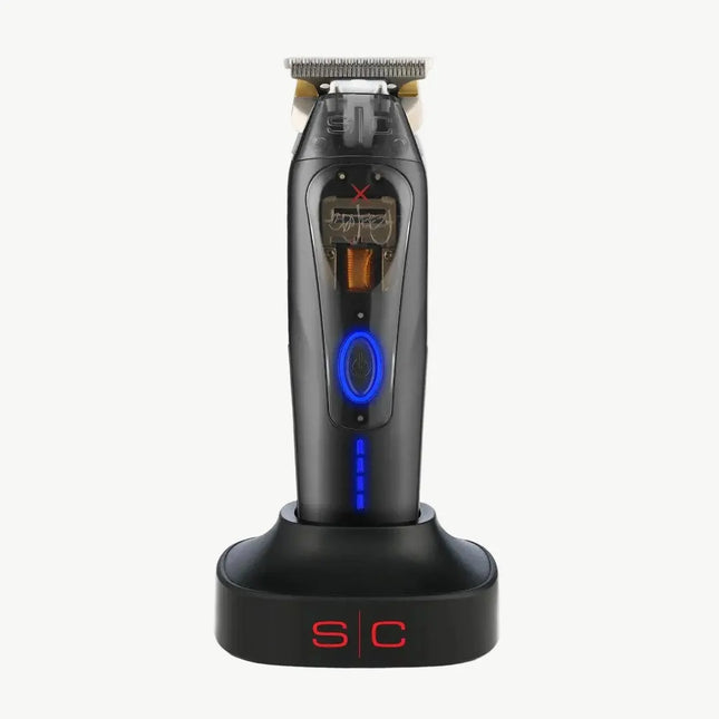 A black cordless electric shaver with blue LED accents, standing upright on a matching black charging dock with red 'S/C' lettering, set against a plain off-white background.