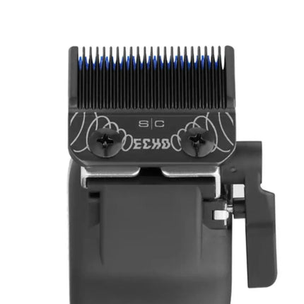 Close-up of a black electric clipper head with blue-tipped cutting teeth, decorative white line art, and the text 'SIC' and 'DEEP' on the metal guide, shown against a plain white background.