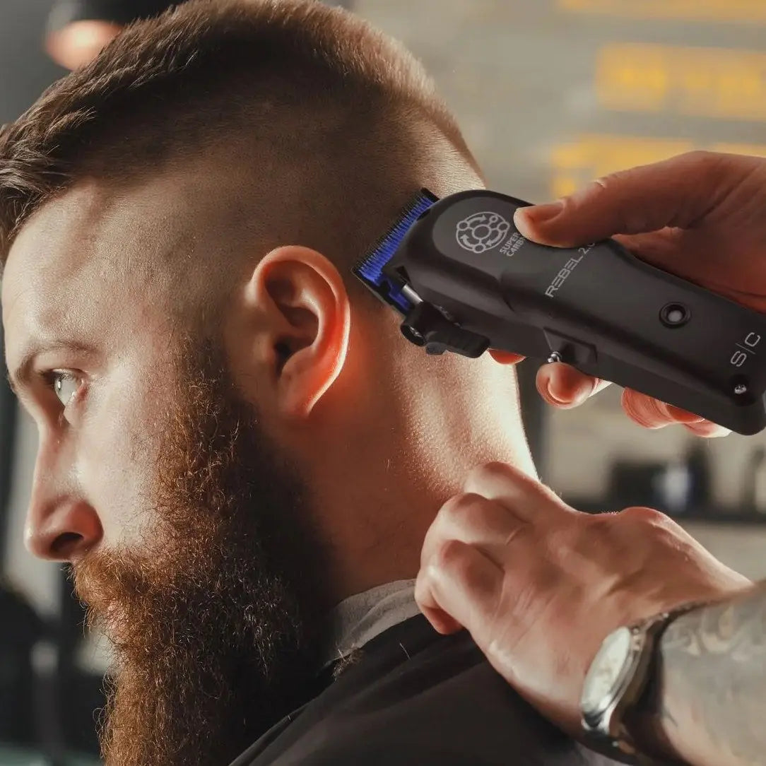 Man getting a haircut with a Rebel 2.0 Professional Hair Clipper in a barbershop setting