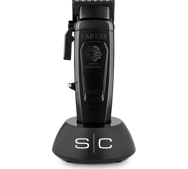 Saber II professional cordless hair clipper with a black body, placed on a charging stand, with the branding visible on the side.