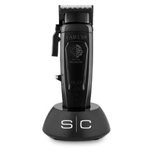 Saber II professional cordless hair clipper with a black body, placed on a charging stand, with the branding visible on the side.