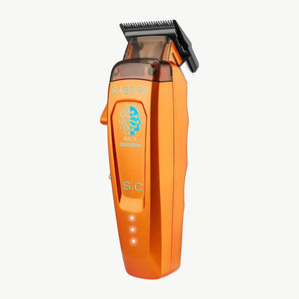 An StyleCraft Saber 2 Professional Hair Clipper – Limited Edition Orange with a black clipper attachment, featuring a blue and gold logo on the front, set against a plain white background.