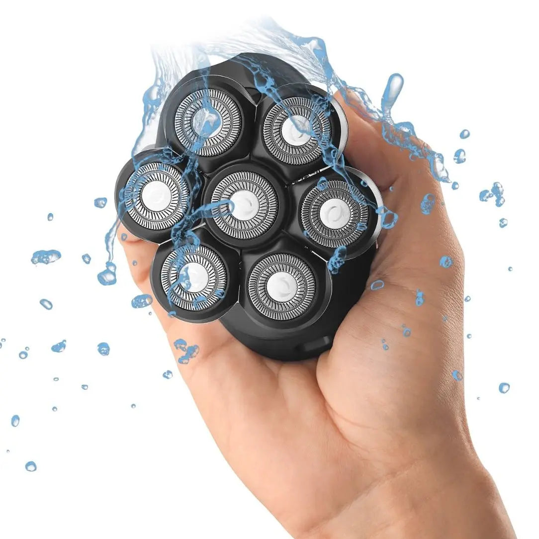 Hand holding a black electric shaver with water splashes on a white background