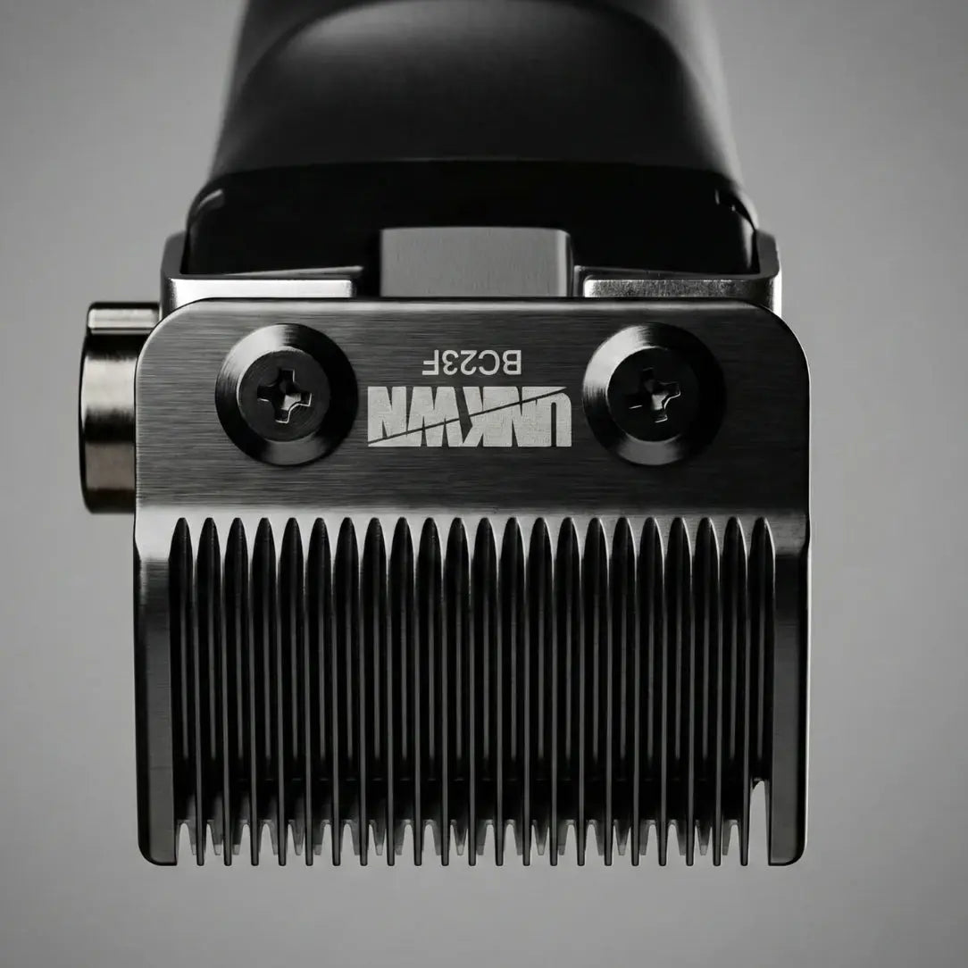 Close-up of a hair clipper head with brand logo on a gray background UNKWN Vortex Cyclone Clipper