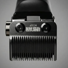 Close-up of a hair clipper head with brand logo on a gray background UNKWN Vortex Cyclone Clipper