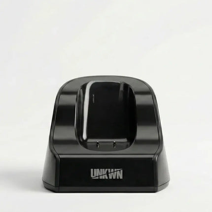Black electronic device dock with 'UNKWN' branding on a white background