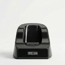 Black electronic device dock with 'UNKWN' branding on a white background