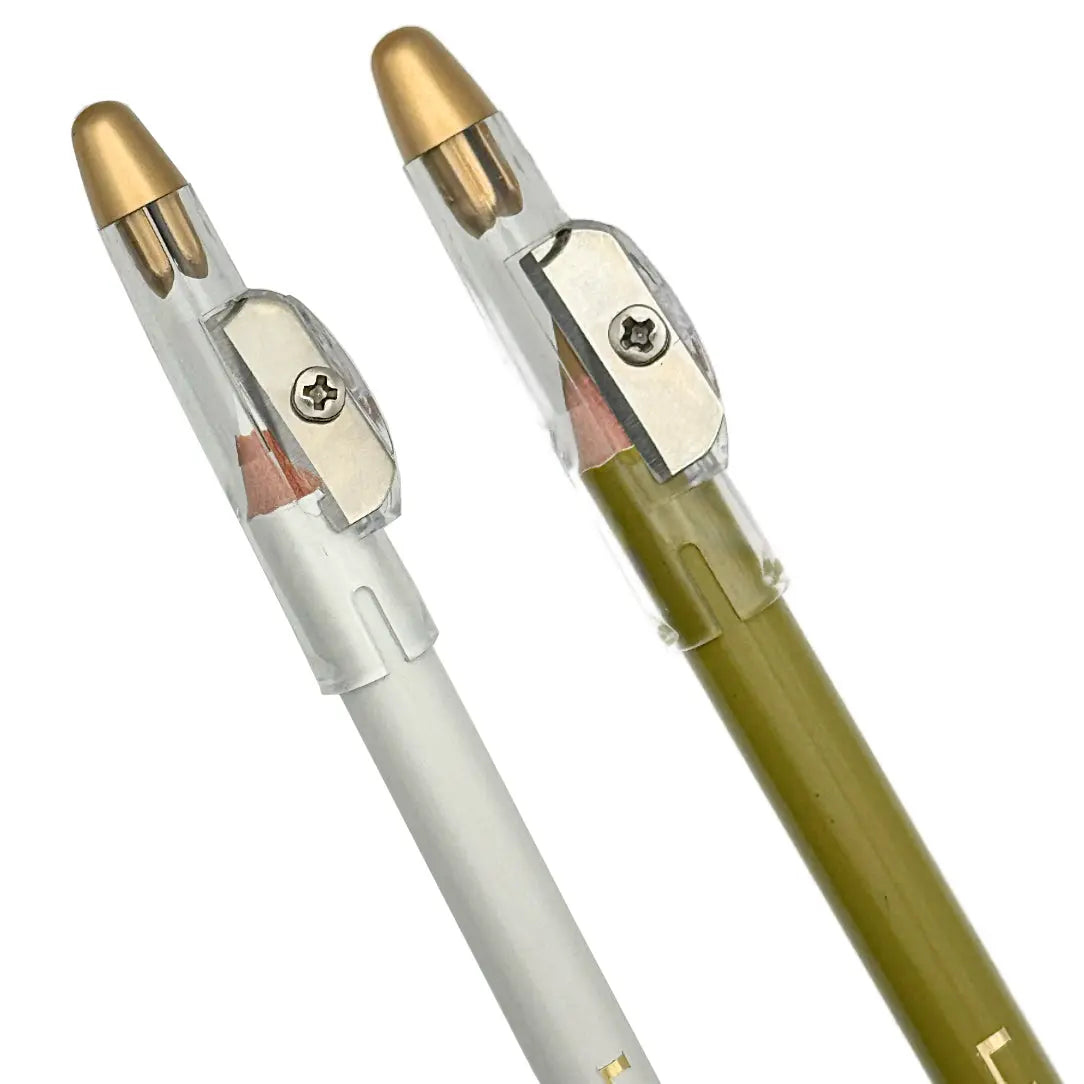 Two Barber Works line-up pencil s, one white and one tan, with gold accents on a white background.