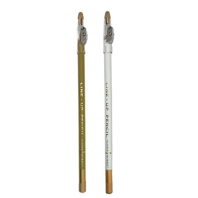 Barber Works  line-up pencil, one gold and one white, on a white background
