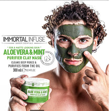 “Woman applying Aloe Vera & Mint Purifier Clay Mask to her cheek in gentle circular motions.”

