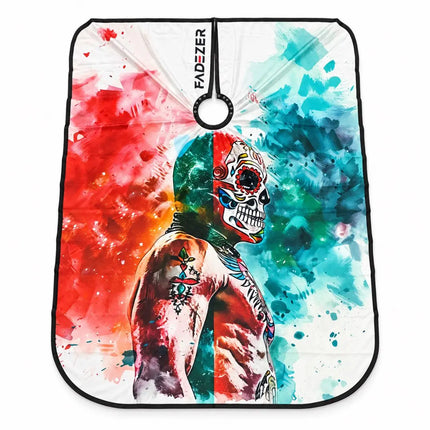 buybarber.com exclusive barber hair cutting cape, featuring a colorful watercolor-style graphic of a tattooed skull figure split by red and blue paint splashes. The brand name 'FADZTER' is printed vertically near the top center, and a black hanging loop is attached at the top.