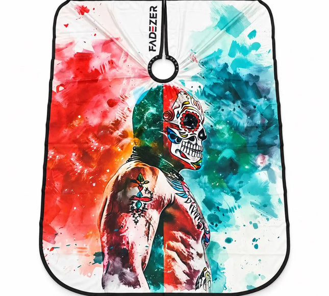 buybarber.com exclusive barber hair cutting cape, featuring a colorful watercolor-style graphic of a tattooed skull figure split by red and blue paint splashes. The brand name 'FADZTER' is printed vertically near the top center, and a black hanging loop is attached at the top.