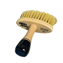 “Close-up of NISHMAN neck brush bristle head for post-cut cleanup.”