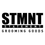 Black and white logo for 'STMNT STATEMENT GROOMING GOODS' on a plain white background.