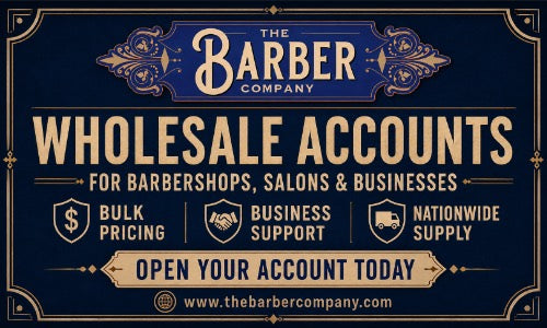 A promotional graphic for The Barber Company offering wholesale accounts for barbershops, salons, and businesses. The design features a dark navy blue background with ornate gold borders and text, highlighting key selling points such as bulk pricing, business support, and nationwide supply.